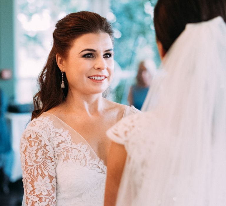 Two Brides in Lace Wedding Dresses Exchanging Vows at Wedding Ceremony