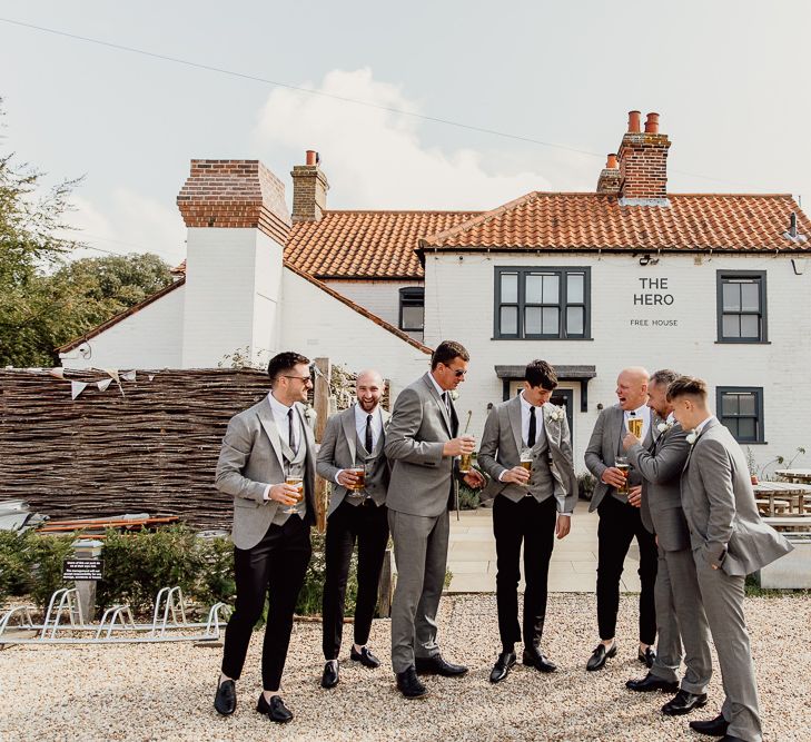 Groom and groomsmen toast the celebration at Norfolk barn wedding