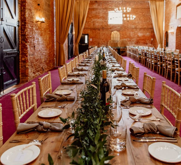 Foliage and candles on trestle tables at Norfolk  barn wedding miChris-53