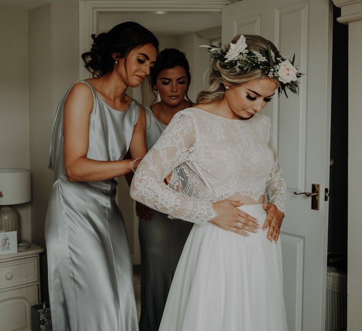 Bride getting ready wearing two piece dress and white floral crown