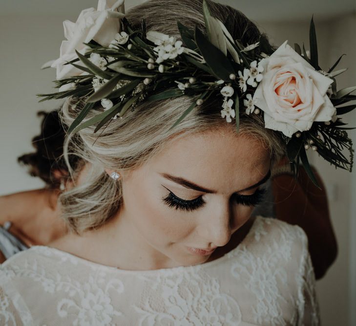 Bride wearing lace bridal top and white floral crown for relaxed country wedding with festival styling