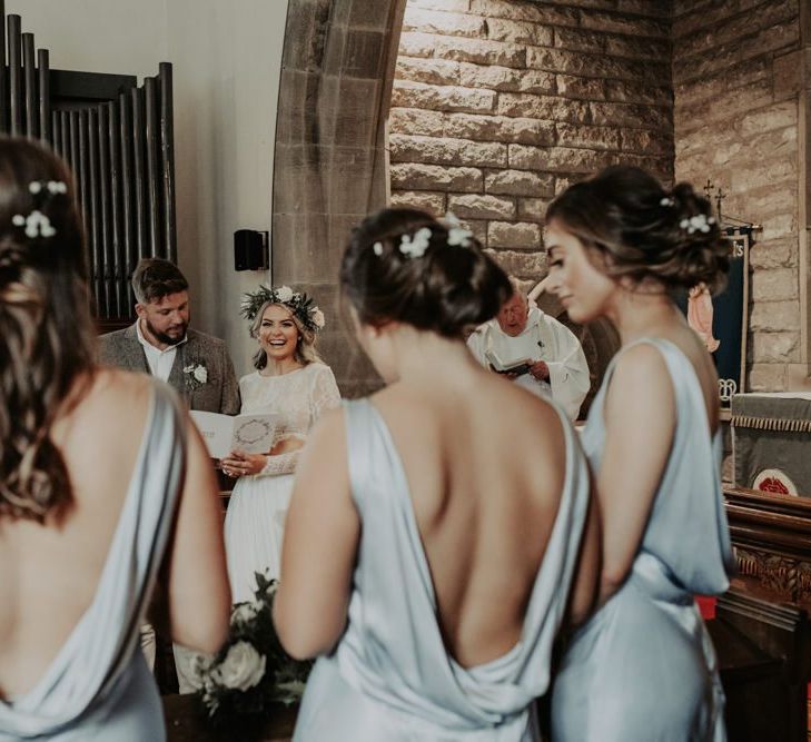 Back of bridesmaid dresses at church ceremony