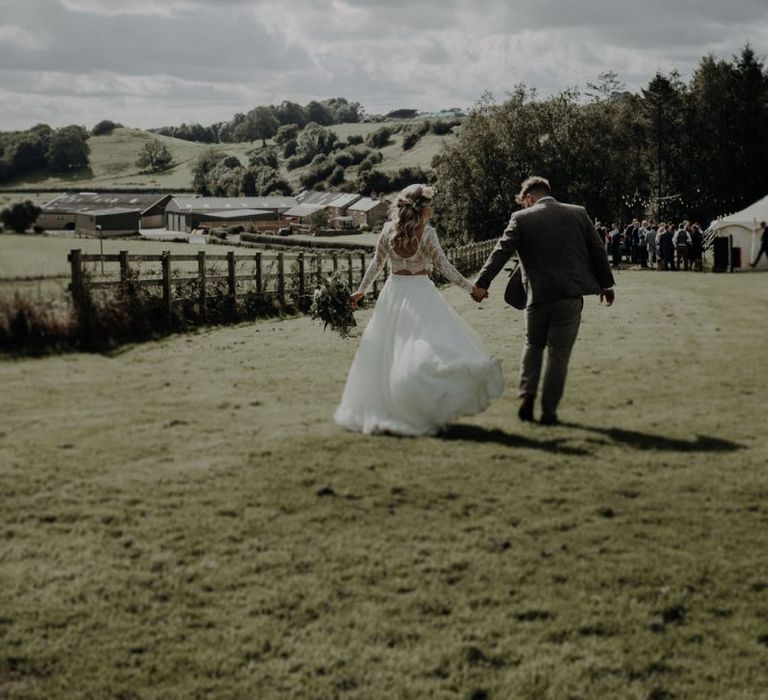 Bride and groom taking in the views of the rolling hills and fields at Hobbit Hill for outdoor wedding