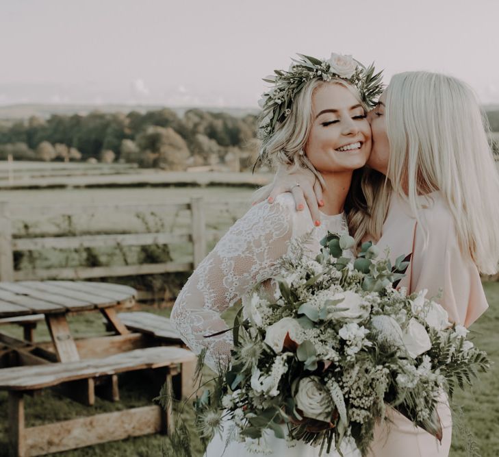 Bride wearing white floral headpiece and two piece bridal dress at Hobbit Hill wedding