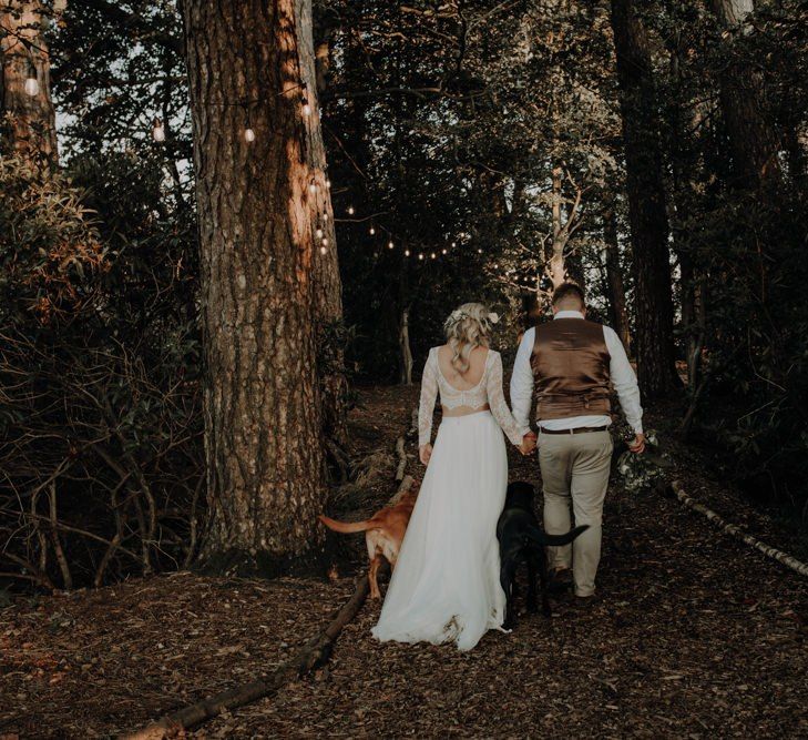 Bride and groom take a moment with their dogs at Hobbit Hill for outdoor wedding with country styling