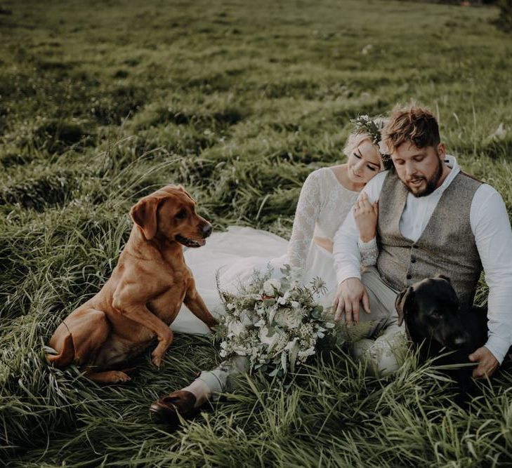 Bride and groom take a moment with their dogs at Hobbit Hill for outdoor wedding with country styling