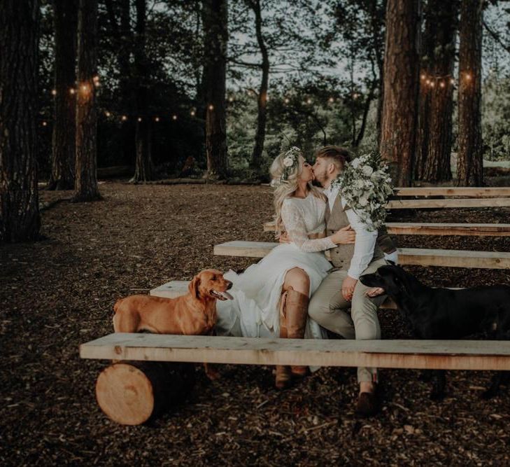 Bride and groom take a moment with their dogs at Hobbit Hill for outdoor wedding with country styling