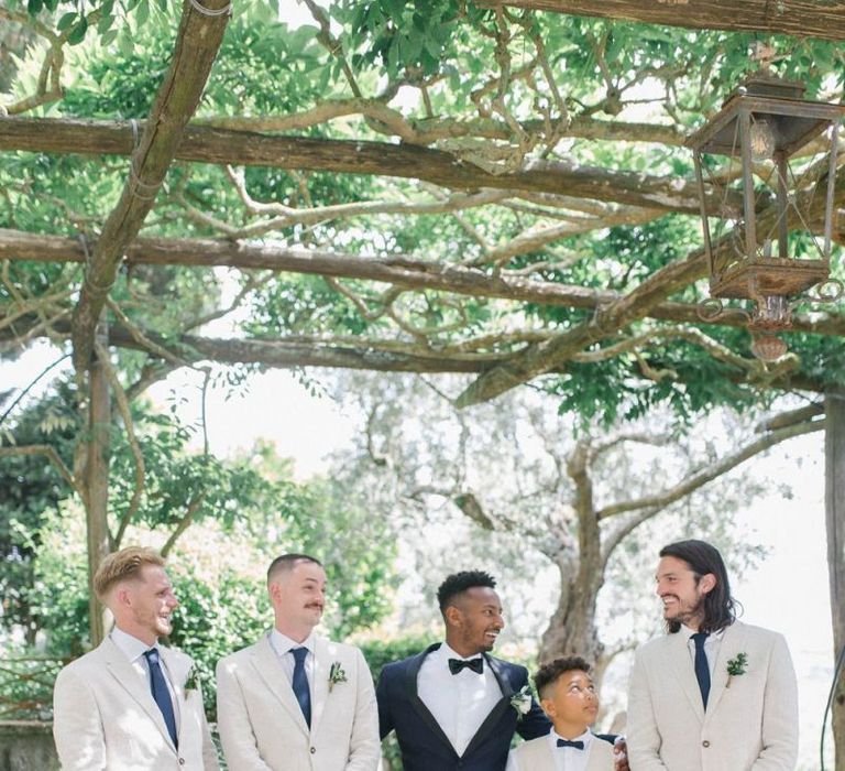 Groom In Blac Tux and Groomsmen In Cream Suits For Destination Wedding