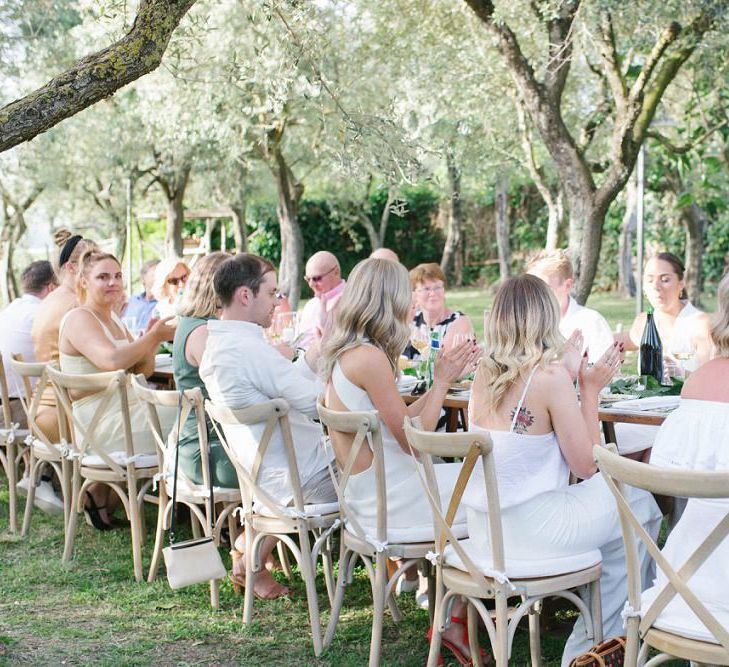 Guests Cheers and Enjoy Outside Wedding In Italy With Lemon Wedding Decor On Table