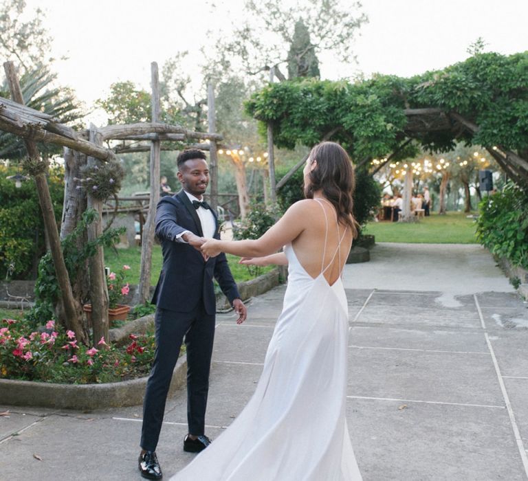 Minimalist Low Back Strappy Wedding Dress With Groom In Tuxedo