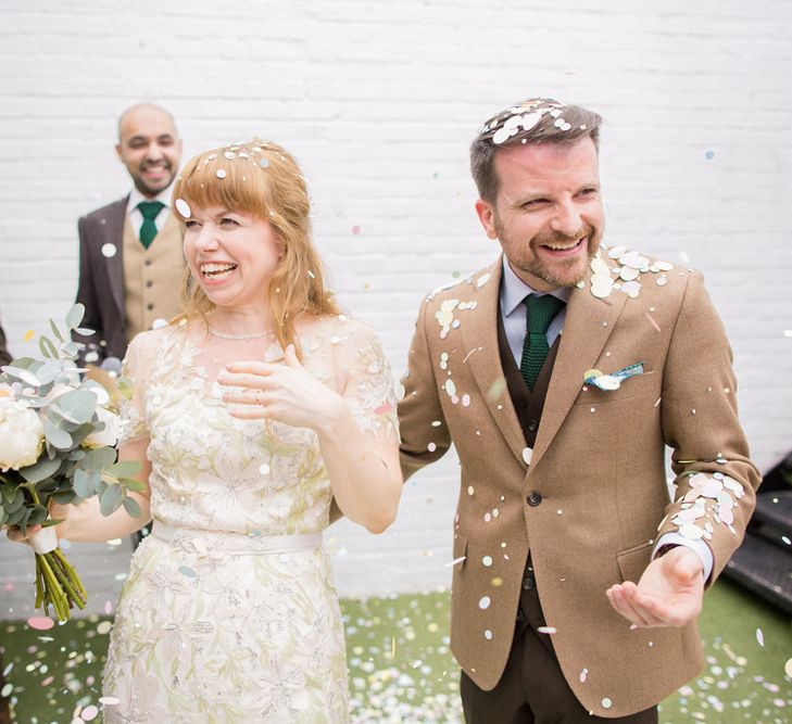 Confetti Moment with Bride in Jenny Packham Cassiopeia Wedding Dress with Groom in Brown Suit