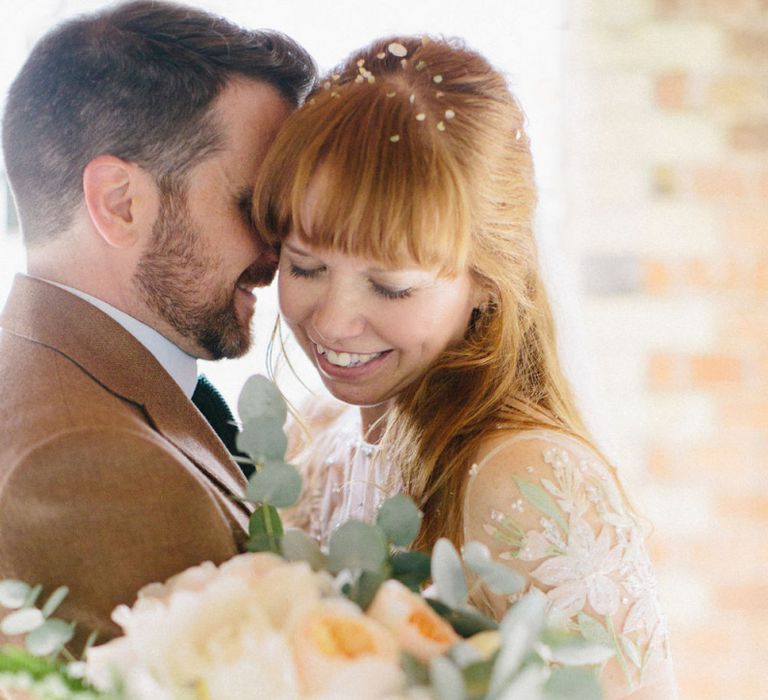 Bride in Floral Jenny Packham Wedding Dress and Groom in Brown Suit