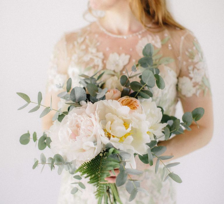 Bride in Light Pink and Green Floral Jenny Packham Wedding Dress Holding a White, Peach and Green Bouquet