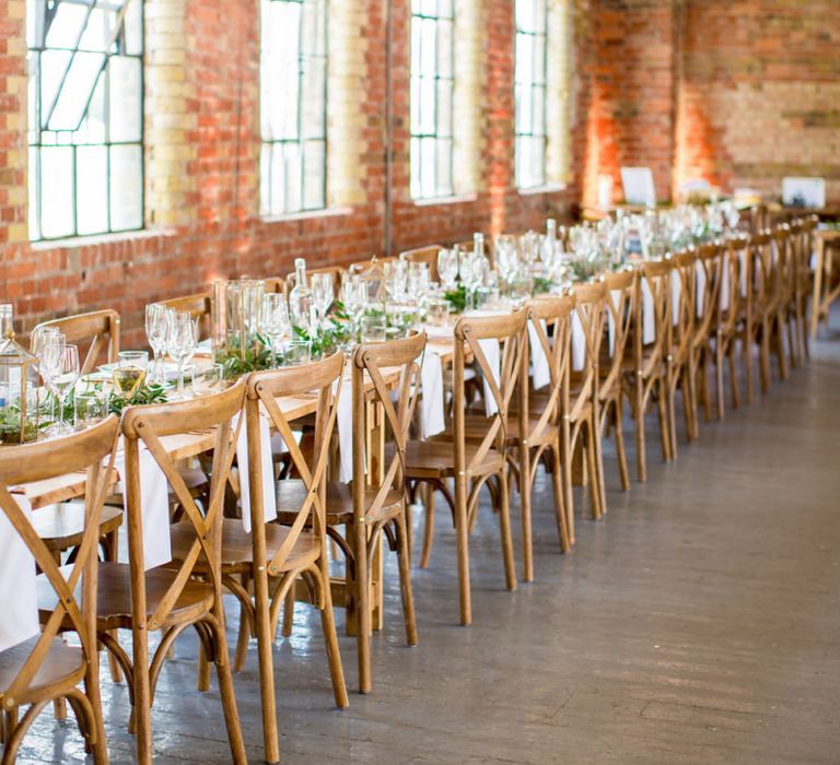 Industrial Wedding Reception at Loft Studio's with Wooden Tables and Chairs and Botanical Flowers