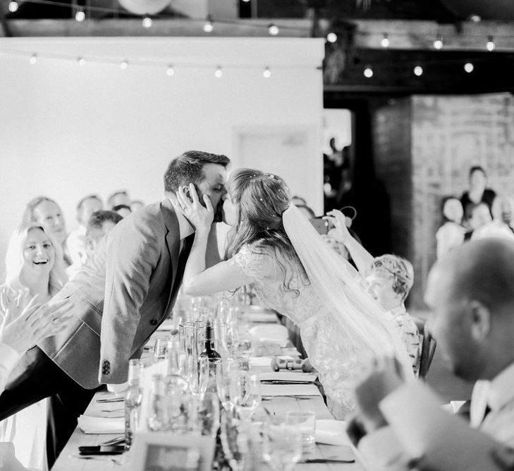 Bride and Groom Kissing During the Wedding Breakfast