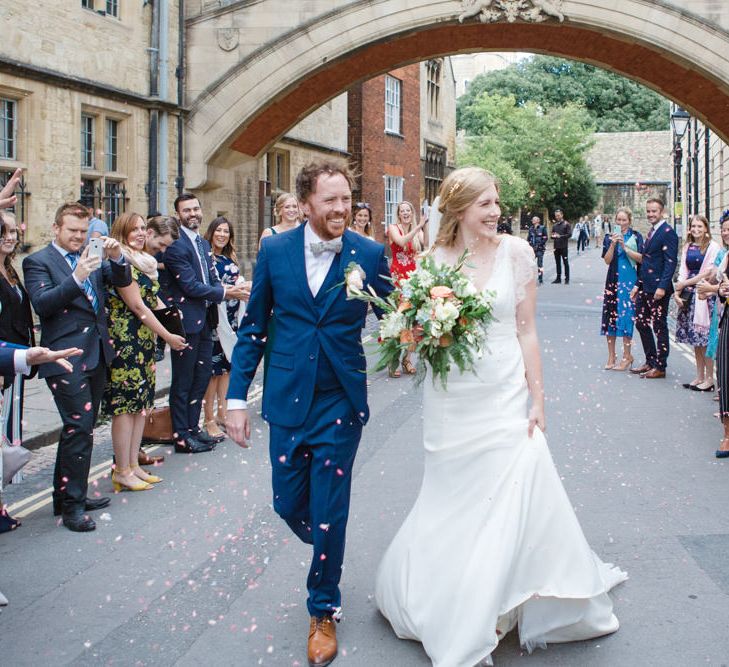 Confetti Moment with Bride in Sassi Holford Tamara Wedding Dress and Groom in Navy Blue Ted Baker Suit