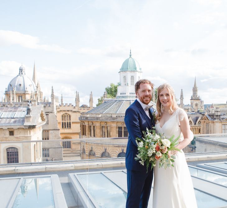 Bride in Sassi Holford Tamara Wedding Dress and Groom in Navy Ted Baker Suit with Views of Oxford