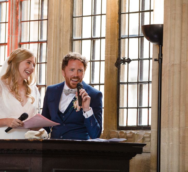 Joint Bride and Groom Speech with Bride in Sassi Holford Tamara Wedding Dress and Groom in Navy Ted Baker Suit