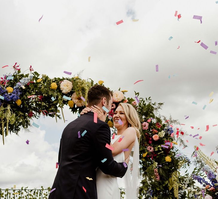 Bride and groom confetti shot at private rooftop ceremony