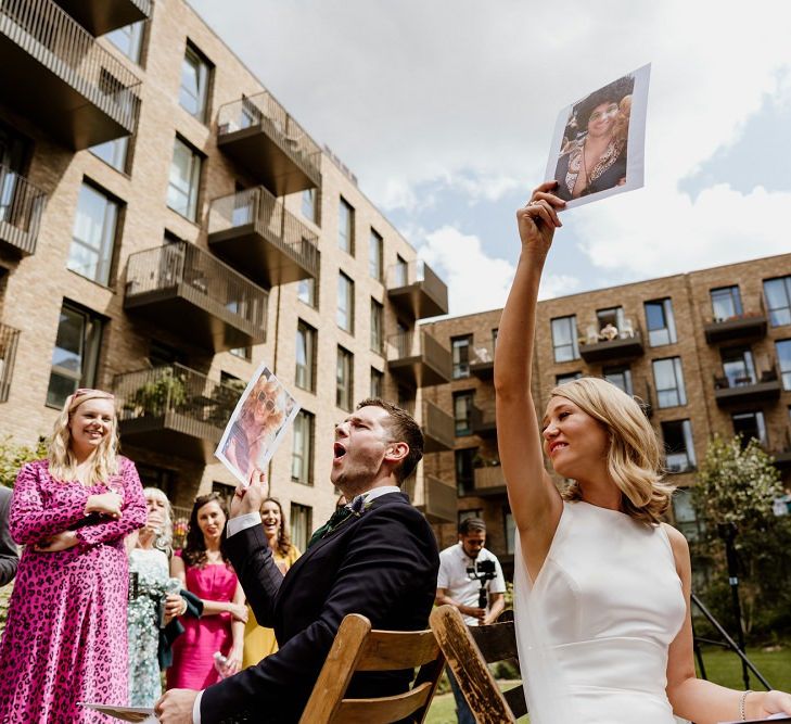 Bright and groom playing wedding games at outdoor wedding in London