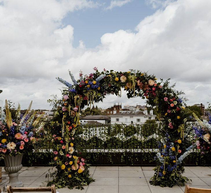 Beautiful floral moon gate at outdoor rooftop wedding in London