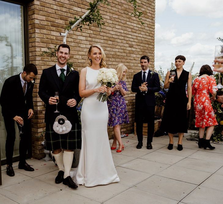 Bride wearing beautiful dress before changing into her bridal jumpsuit