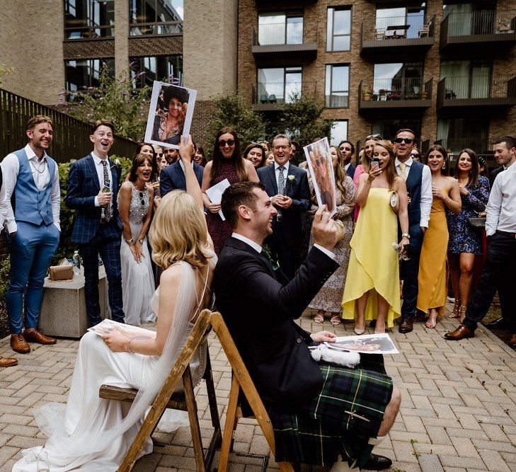 Wedding games at outdoor celebration in London with bridal jumpsuit