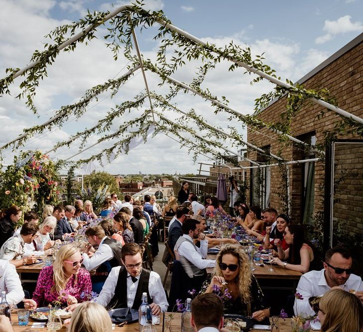 Hanging foliage and floral decor at private rooftop wedding