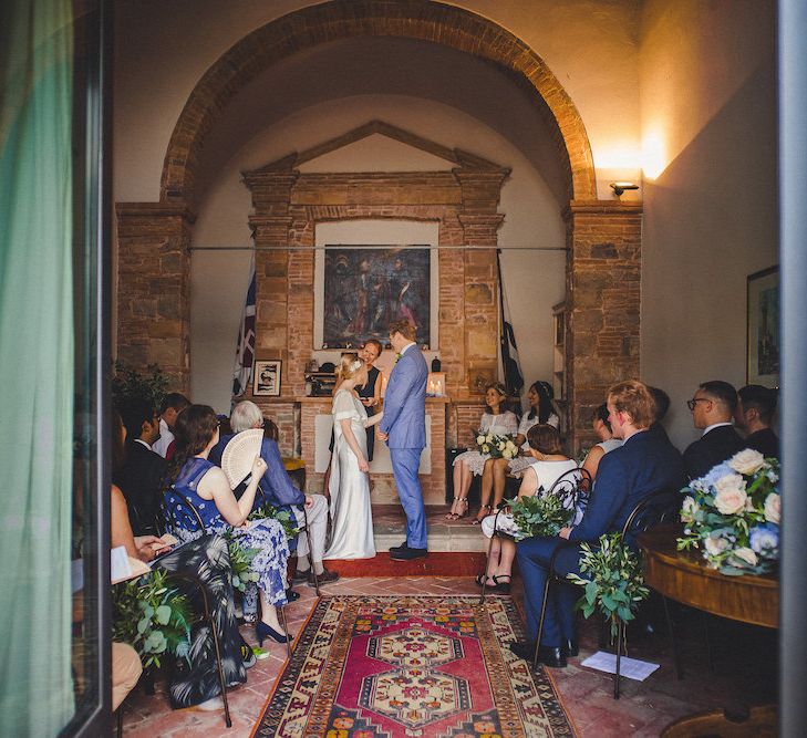 Intimate Prosecco Pool Party Wedding in Tuscany. Bride wears Livio Lacurre Gown, Groom wears Beggars Run Custom Suit. Photography by Livio Lacurre.