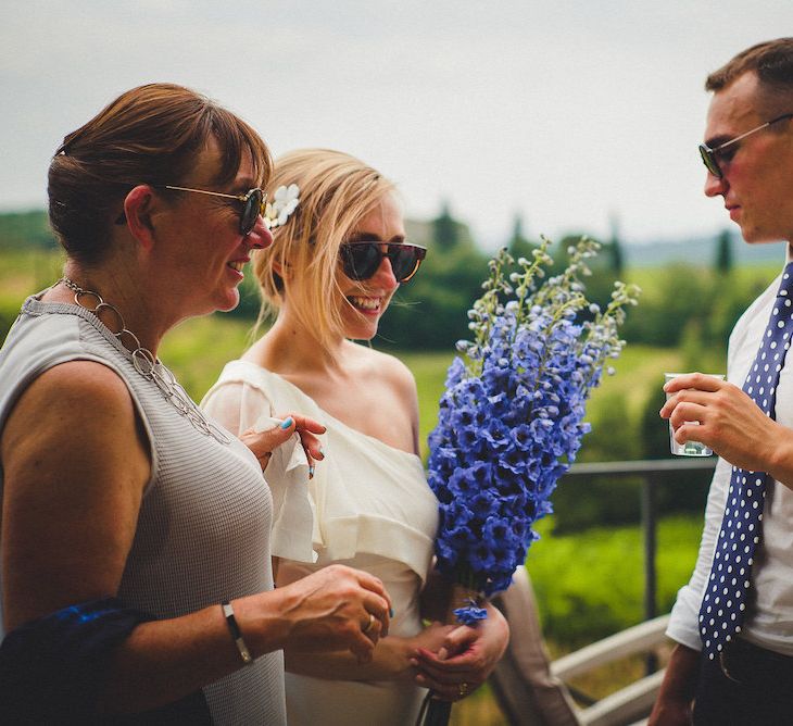 Flowers by Stiatti Fiori. Intimate Prosecco Pool Party Wedding in Tuscany. Bride wears Livio Lacurre Gown, Groom wears Beggars Run Custom Suit. Photography by Livio Lacurre.