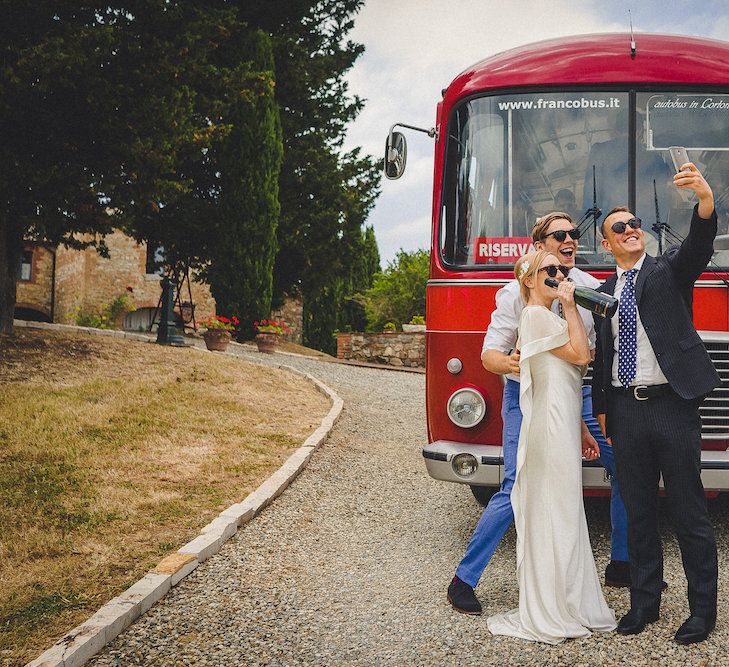 Vintage Bus Wedding Transport from Drive in Style. Intimate Prosecco Pool Party Wedding in Tuscany. Bride wears Livio Lacurre Gown, Groom wears Beggars Run Custom Suit. Photography by Livio Lacurre.