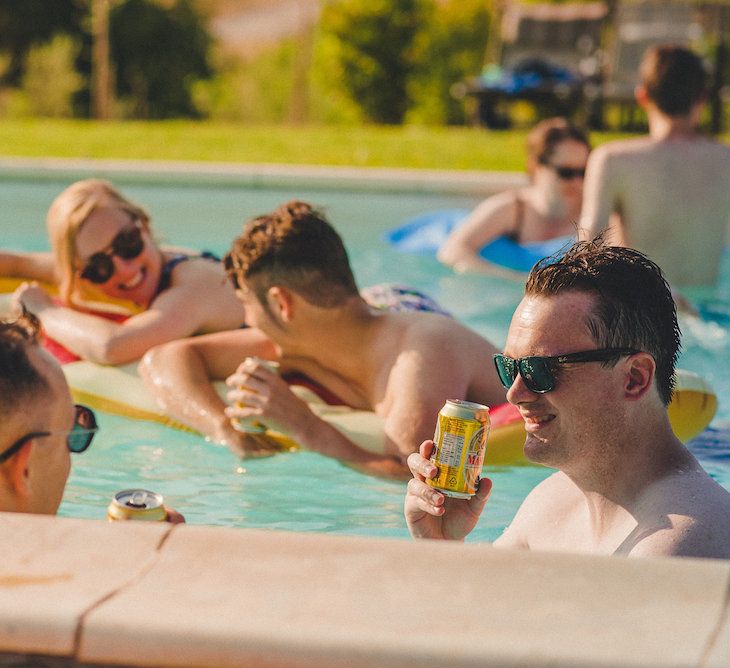 Intimate Prosecco Pool Party Wedding in Tuscany. Bride wears Livio Lacurre Gown, Groom wears Beggars Run Custom Suit. Photography by Livio Lacurre.