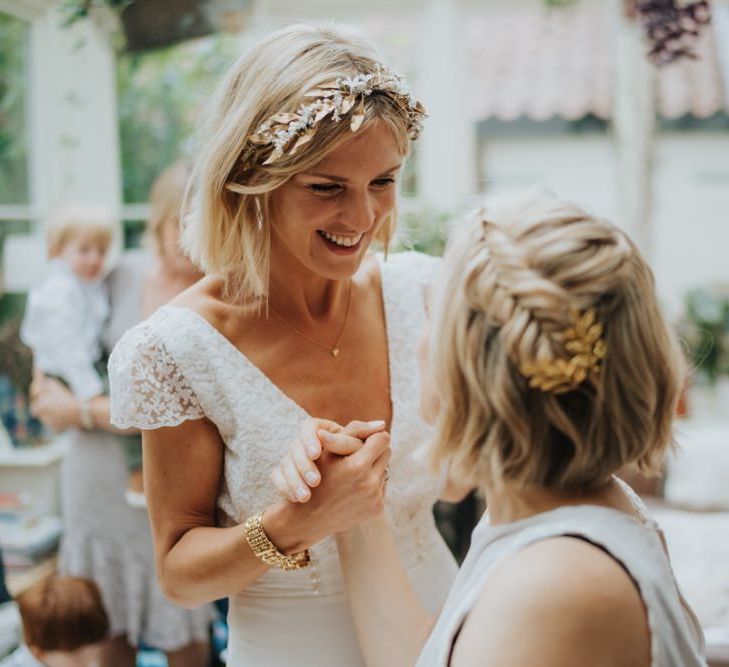 Bride wearing a beautiful laced top bridal dress and gold embellished headband