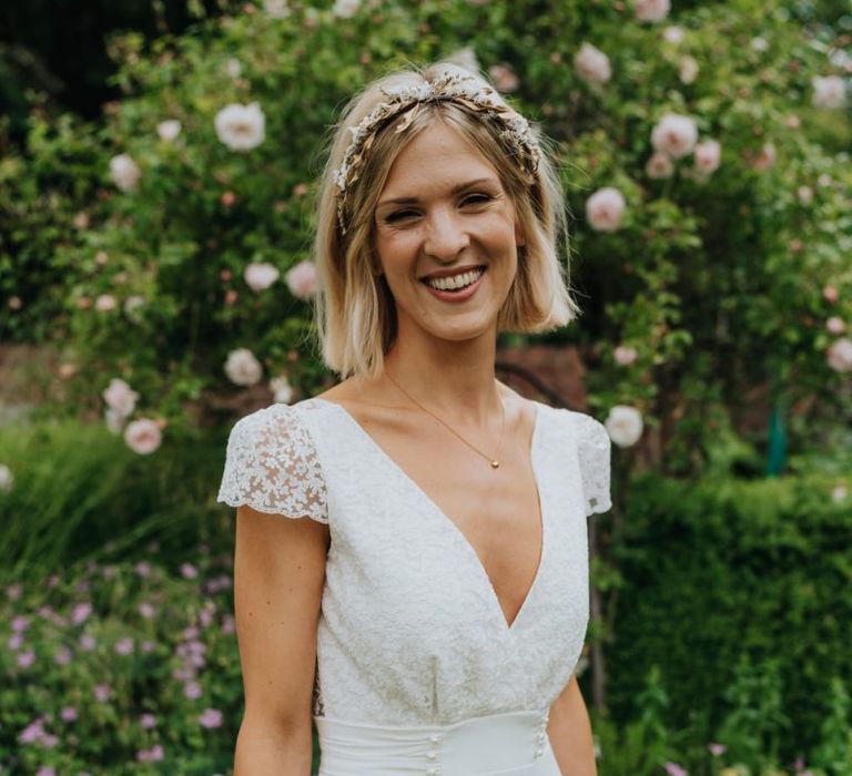 Bride wearing a beautiful laced top bridal dress and gold embellished headband at Newburgh Priory