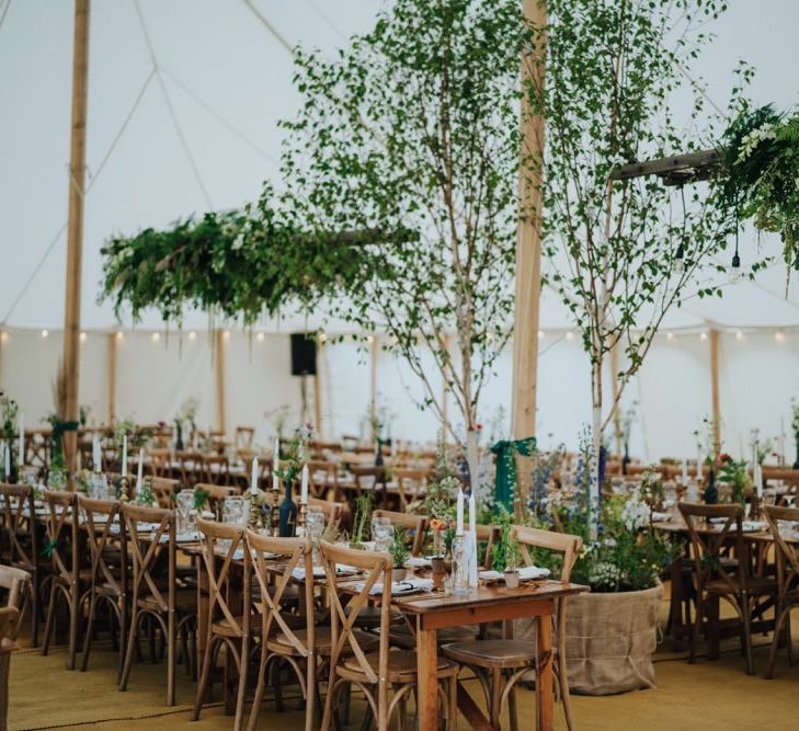 Marquee reception with hanging foliage decor