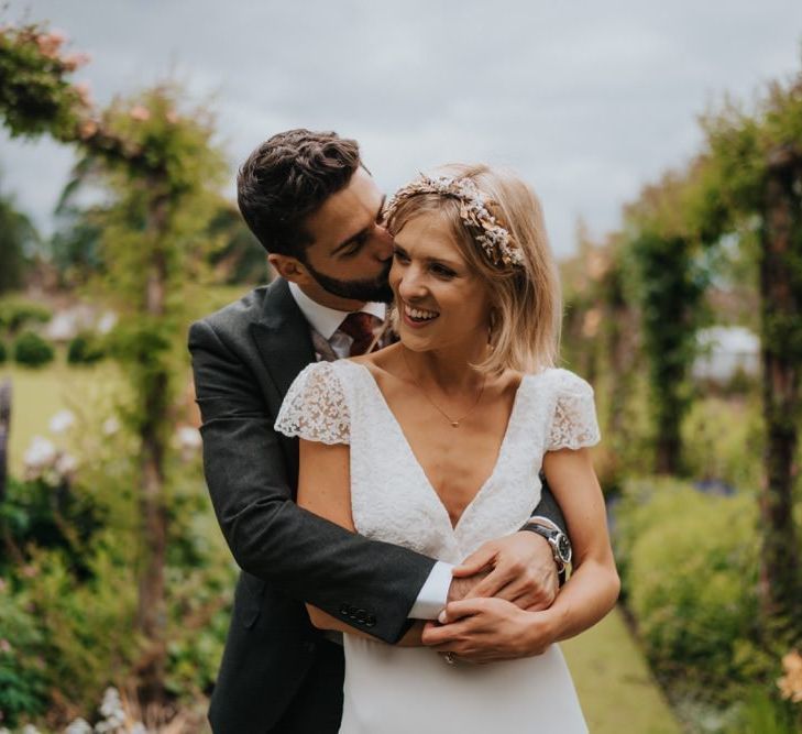 Bride and groom embrace in the gardens at Newburgh Priory for outdoor wedding