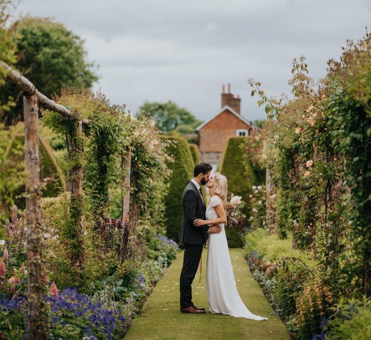 Bride and groom embrace in the gardens at Newburgh Priory for outdoor wedding