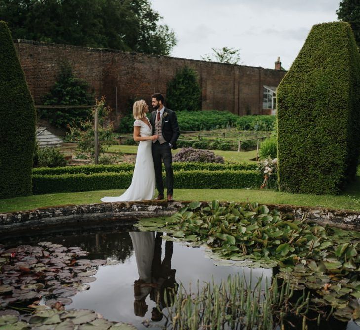 Bride and groom embrace in the gardens at Newburgh Priory for outdoor wedding