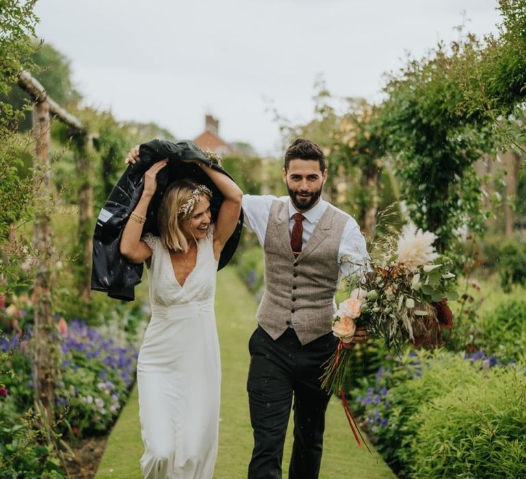 Bride and groom get caught in the rain at spring wedding in Yorkshire