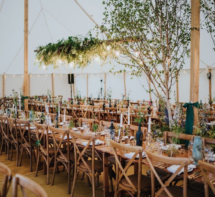 Marquee decor with white floral and foliage decor with gold touches