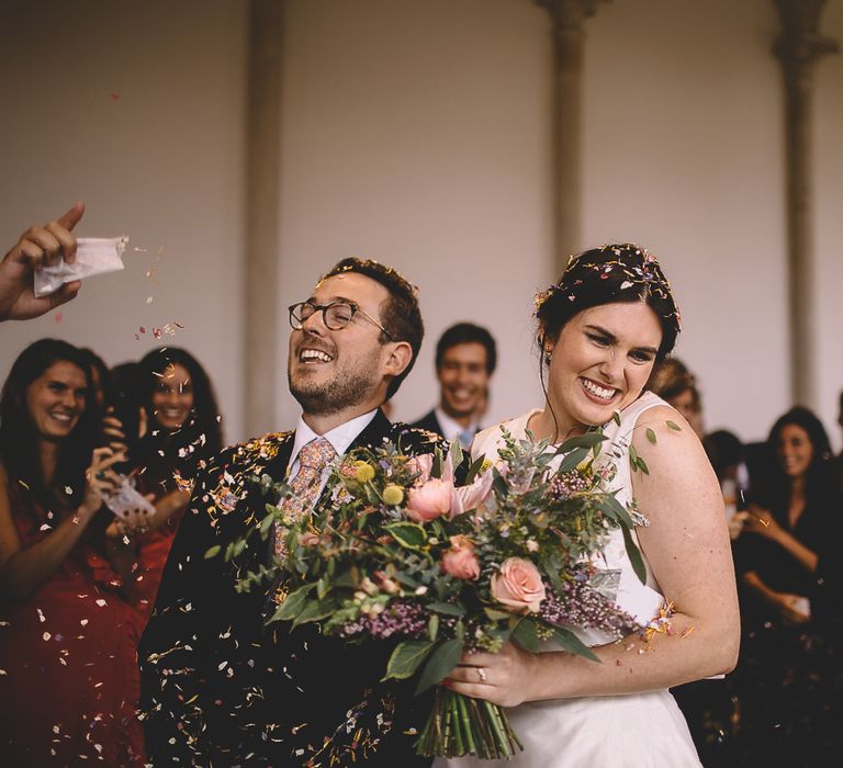 Bride and Groom Laughing During Confetti Moment