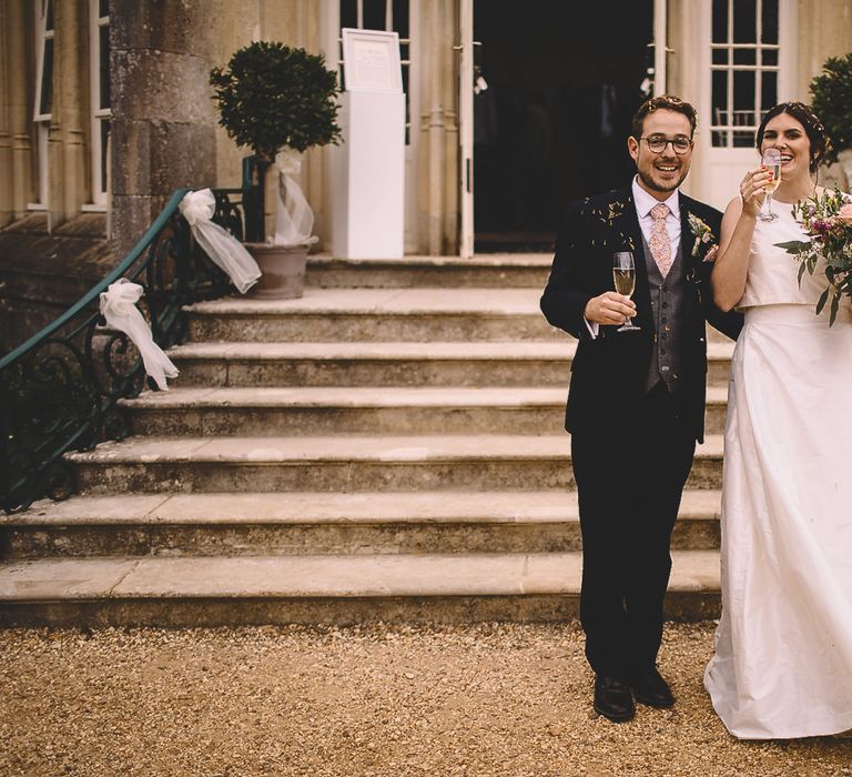 Bride in Homemade Wedding Dress and Groom in Dress2Kill Suit Just Married