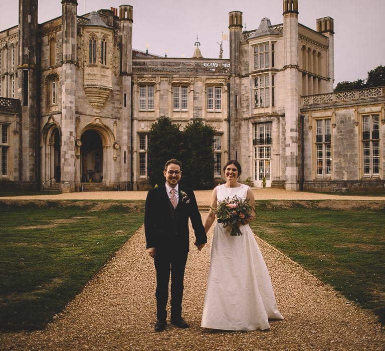 Bride and Groom in Front of Highcliffe Castle in Dorset