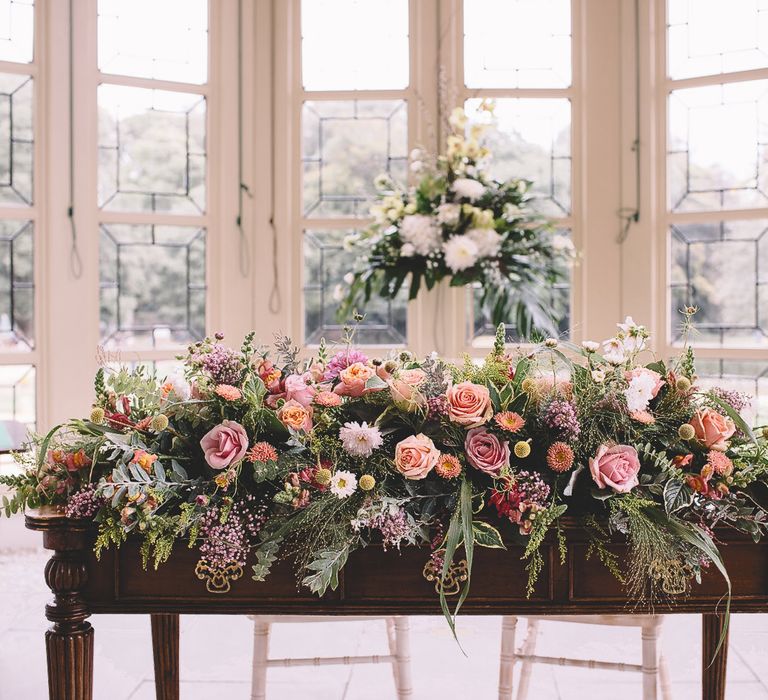 Wedding Floral Arrangement with Foliage and Pink and Peach Roses