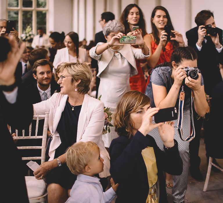 Wedding Guests Taking Pictures of The bride and Groom