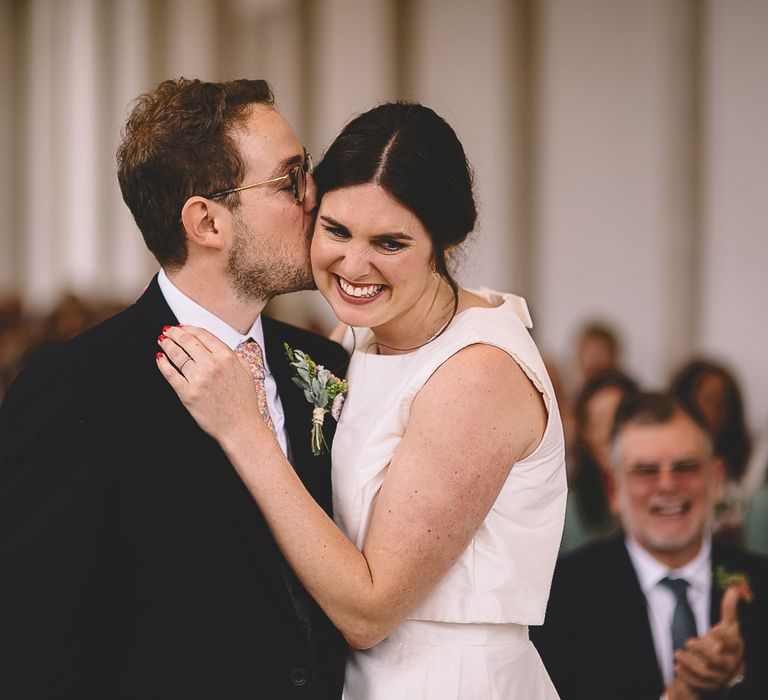 Groom Kissing His Bride During The Wedding Ceremony