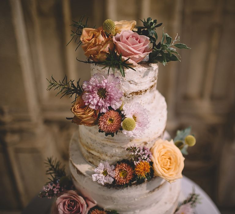 Semi Naked Wedding Cake with Pink, Yellow an Peach Wedding Flowers