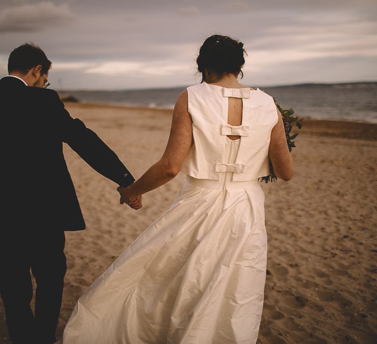 Bride in Homemade Wedding Dress with Bow Back and Groom in Dress2Kill Suit on the Beach