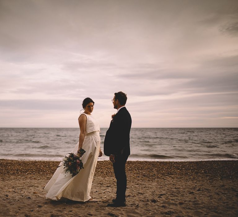 Coastal Portrait of Bride in Homemade Wedding Dress with Bow Back and Groom in Dress2Kill Suit