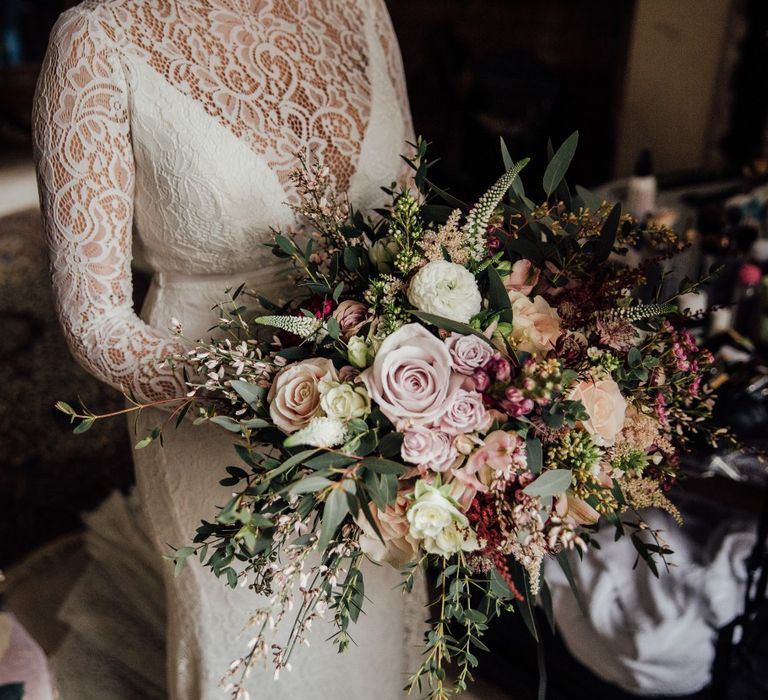 Bride wearing Karen Willis Holmes Bridal with wild flowers